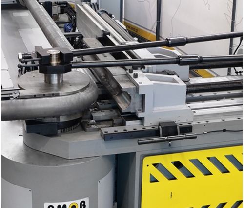 CNC pipe bending machine shaping a metal tube with precision